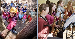 Eine Schülerin klettert gesichert auf einen Baum. Mädchen proben für ein Schulprojekt in der Jugendherberge.